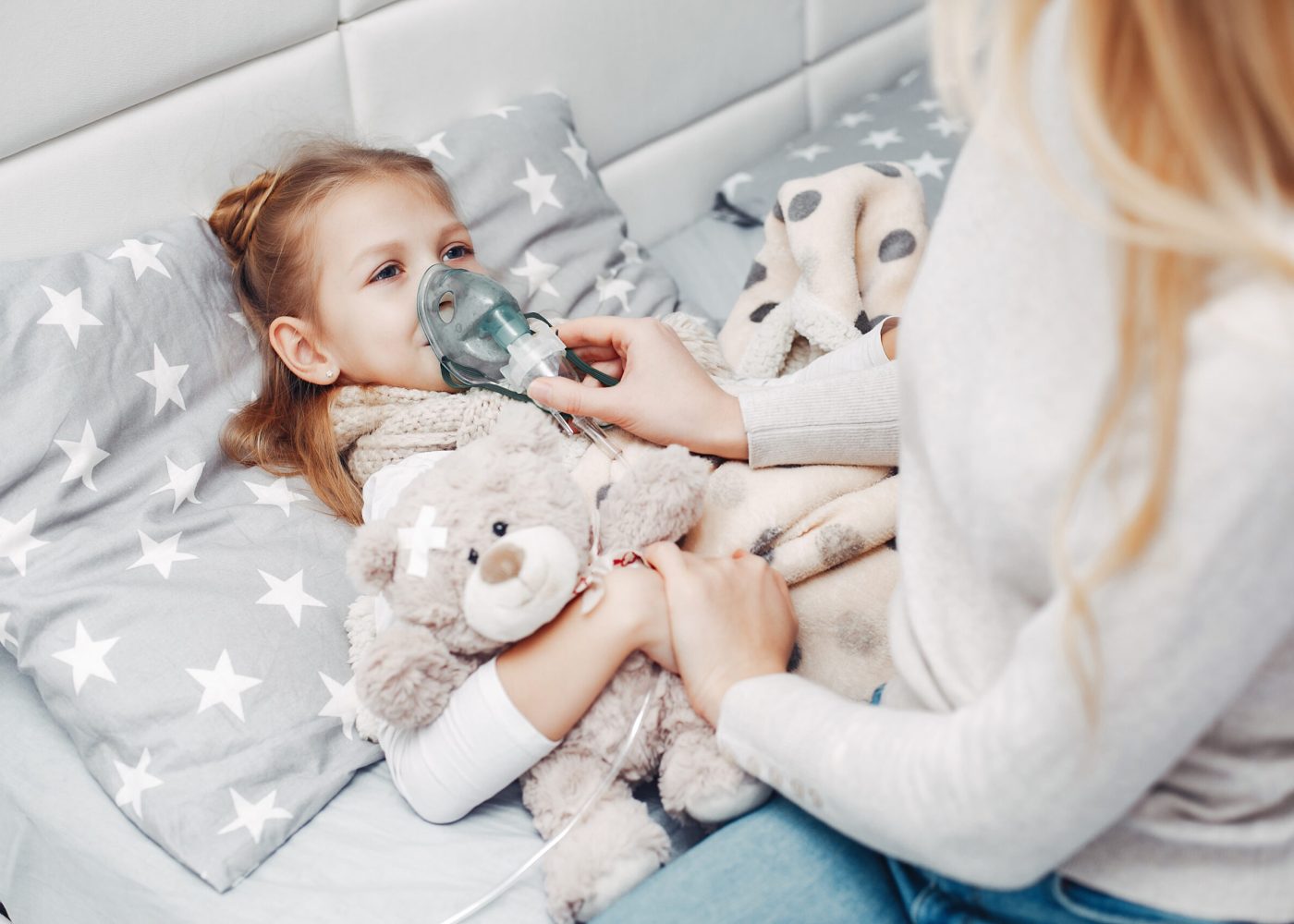 Illnes little girl. Mother with daughter. Child lying in a bed